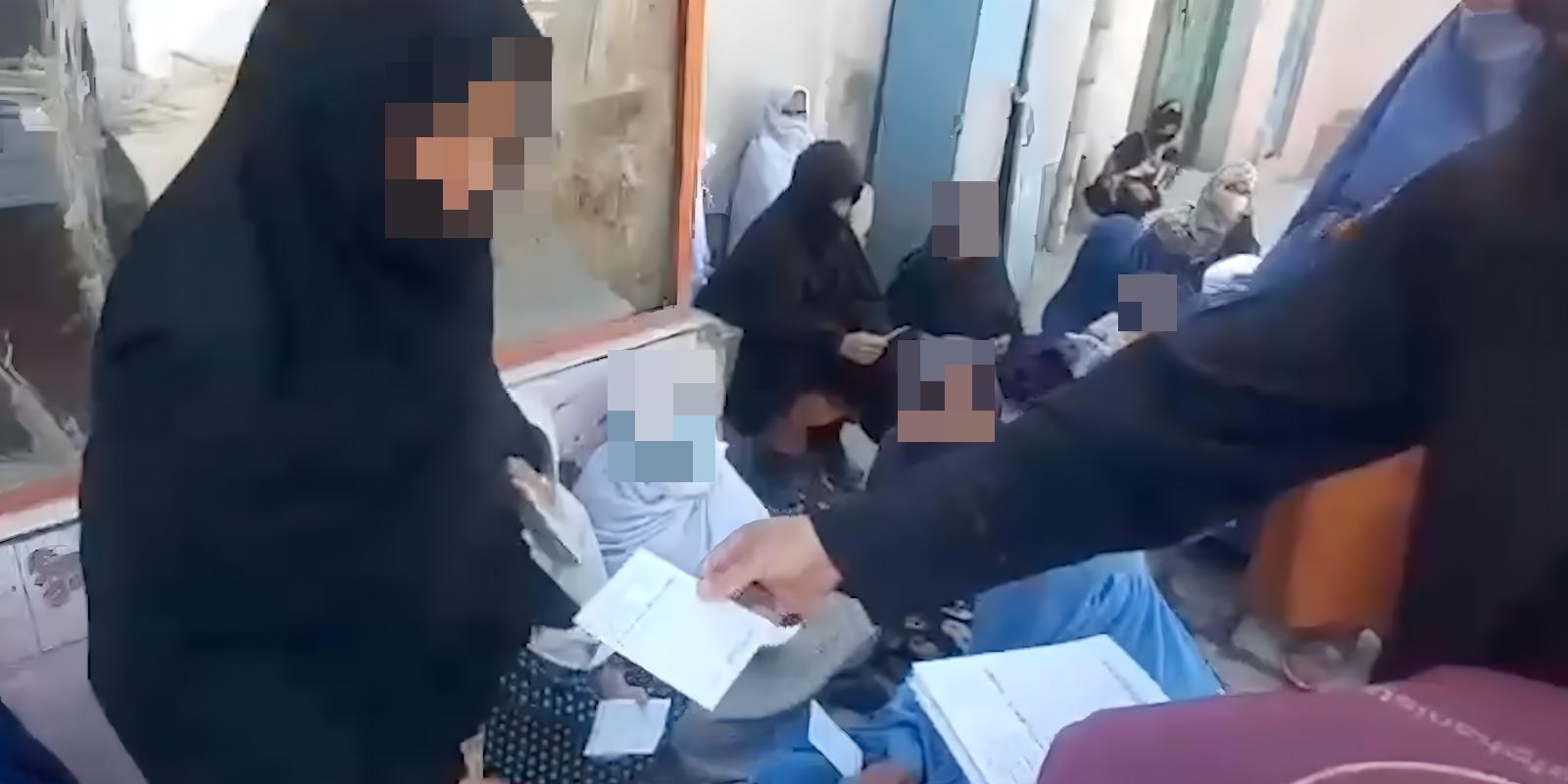 Mothers of Afghanistan staff give bread vouches to widows