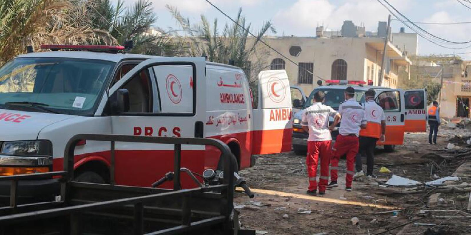 Paramedics from the Palestine Red Crescent attempt to reach injured individuals in a conflict area