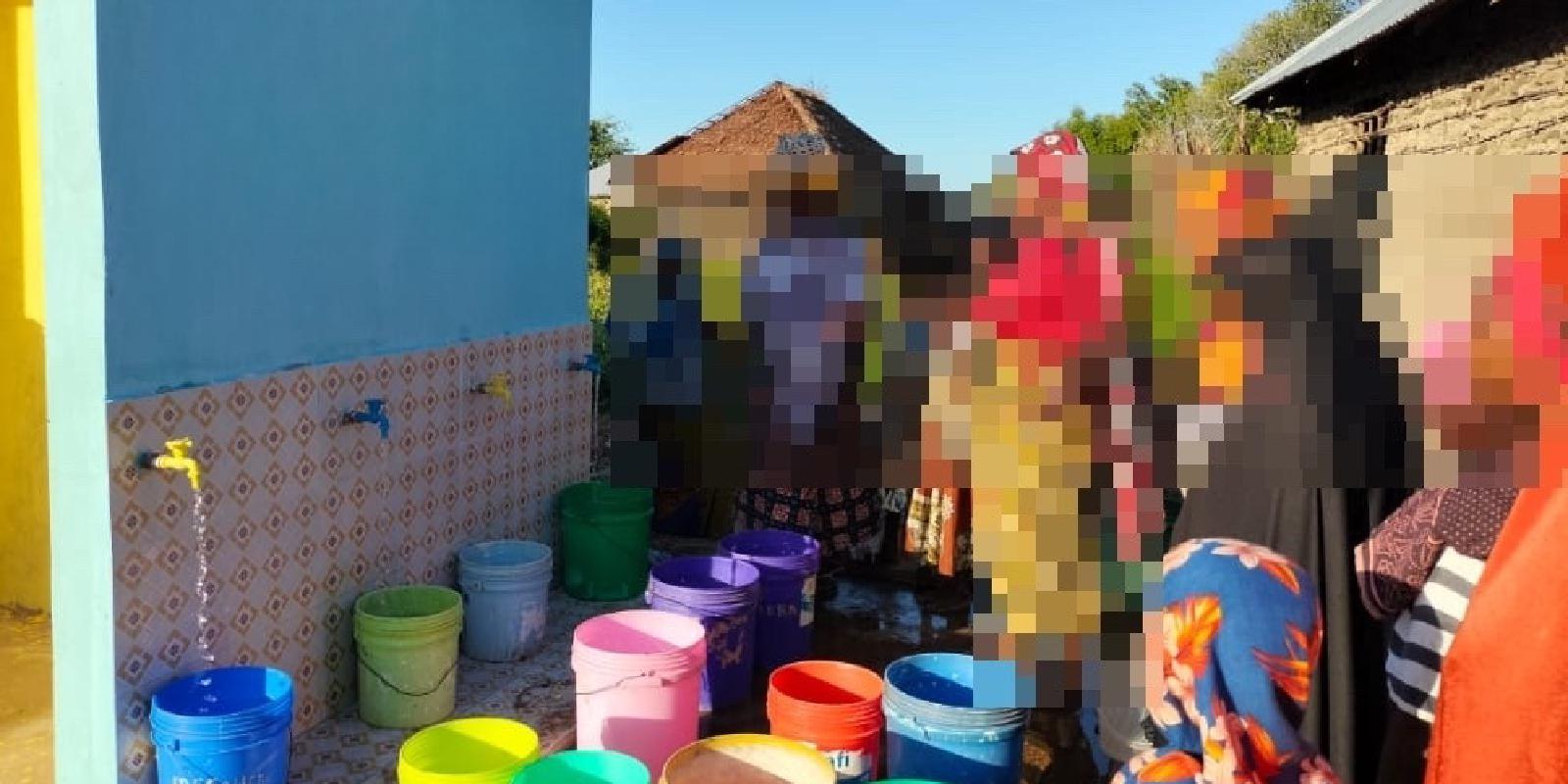 Women gather to collect clean water from the new installation